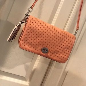Coral perforated tassel crossbody by Coach